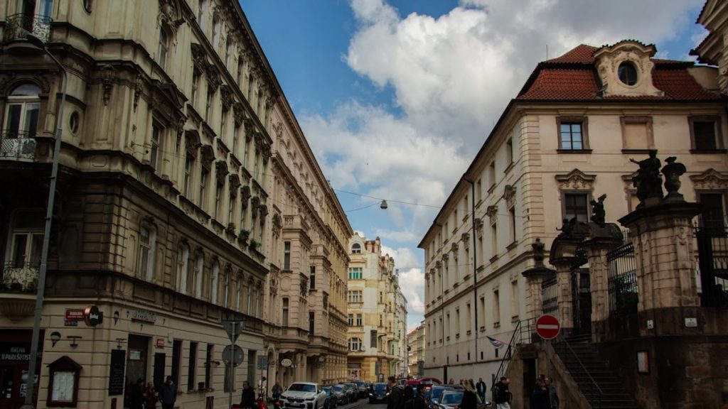 Street scene with historic buildings and people crossing road