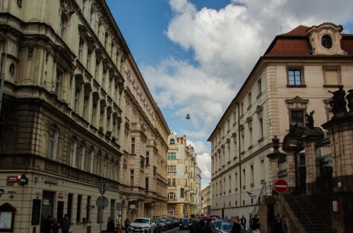 Street scene with historic buildings and people crossing road